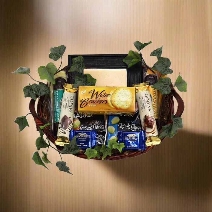 Woven gift basket with snack packages and a dark picture frame on top