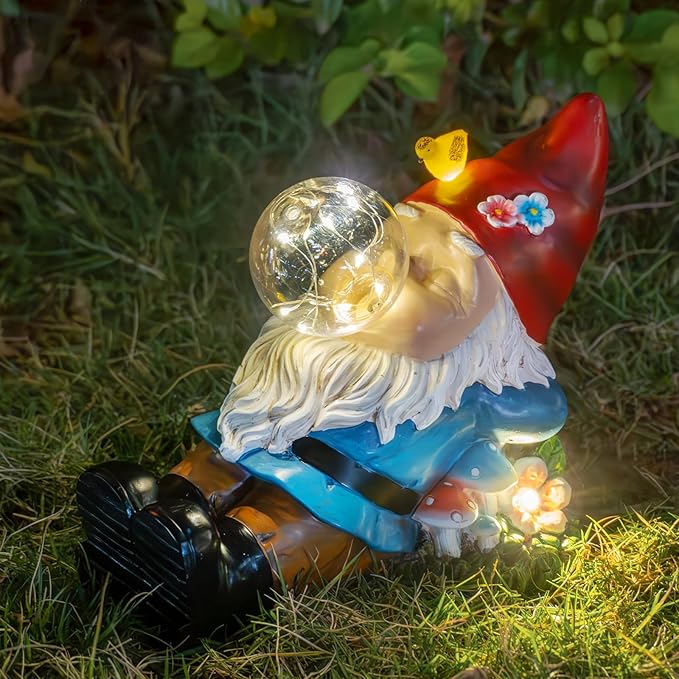 Kneeling solar garden gnome statue with red hat, white beard, and glowing orb
