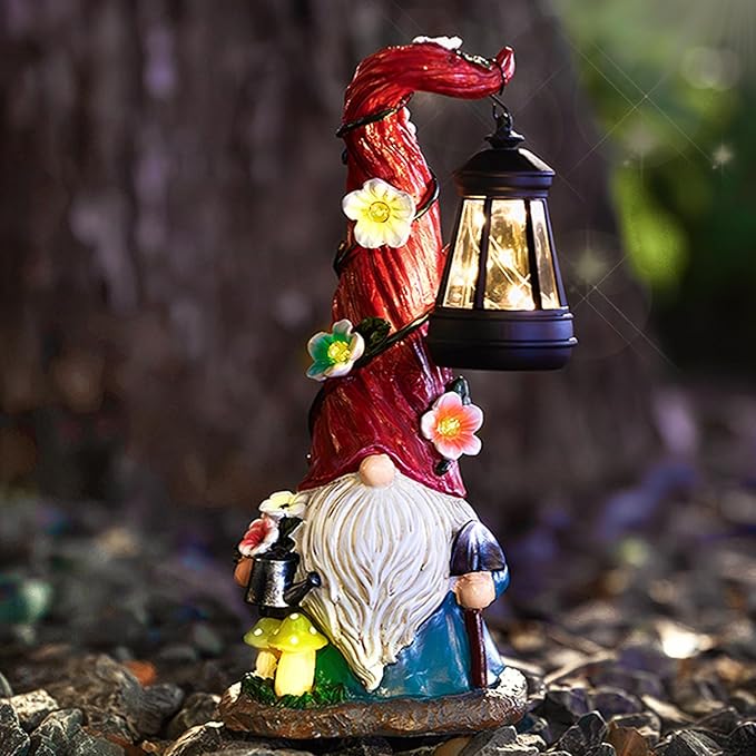 Solar garden gnome statue holding a black lantern with warm glowing light