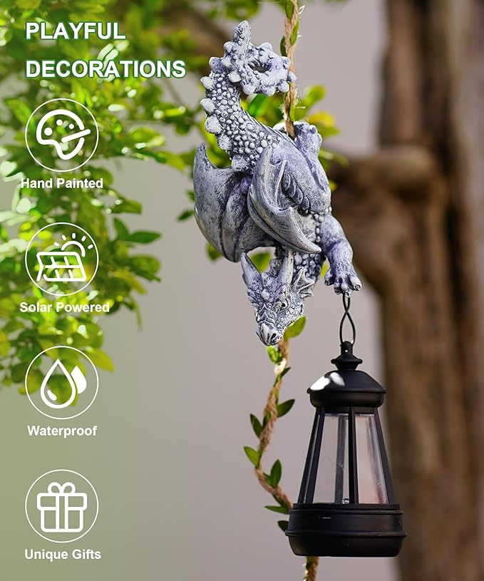 Solar dragon garden ornament with hanging black lantern on a leafy vine