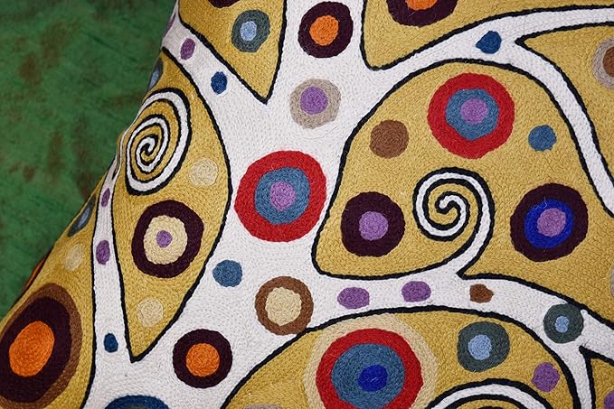 Decorative pillow cover close-up with yellow base and multicolor circular swirl pattern
