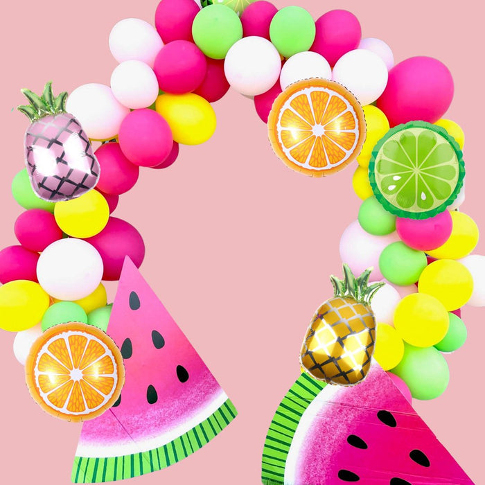 Fruit balloon arch with pink and yellow pineapple mylar balloons and citrus accents