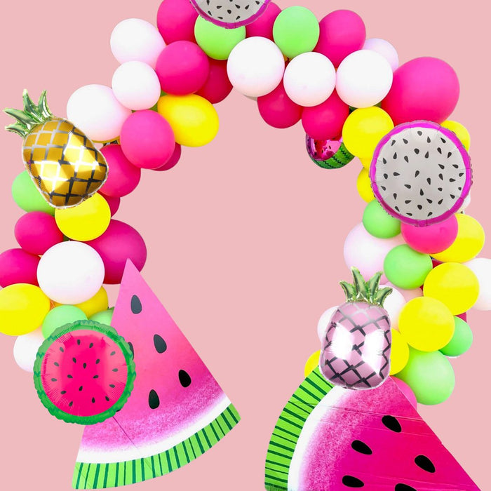 Fruit balloon arch with pink and yellow pineapple mylar balloons and speckled fruit