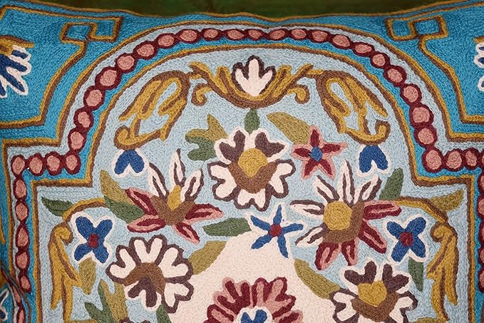 Turquoise pillow cover with central floral medallion and pink beaded-style border