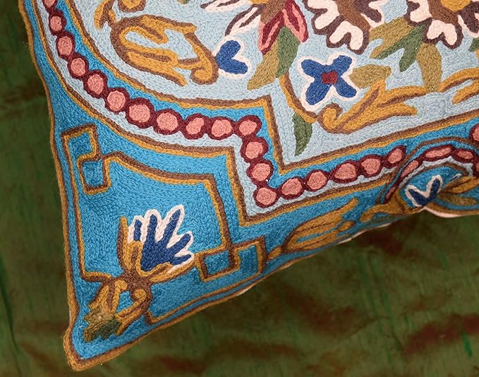 Turquoise embroidered pillow cover showing edge and corner floral border motifs