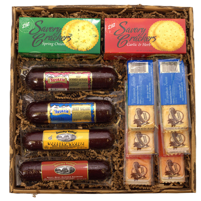 Charcuterie gift box filled with packaged sausages, crackers, and cheese snacks
