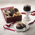 Chocolate desserts on plates with maroon gift box and red ribbon