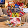 Movie night gift basket with red-and-white popcorn tub and colorful candy snacks