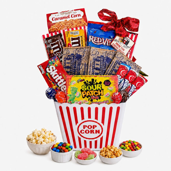 Movie night gift basket with red striped popcorn bucket and assorted packaged candies