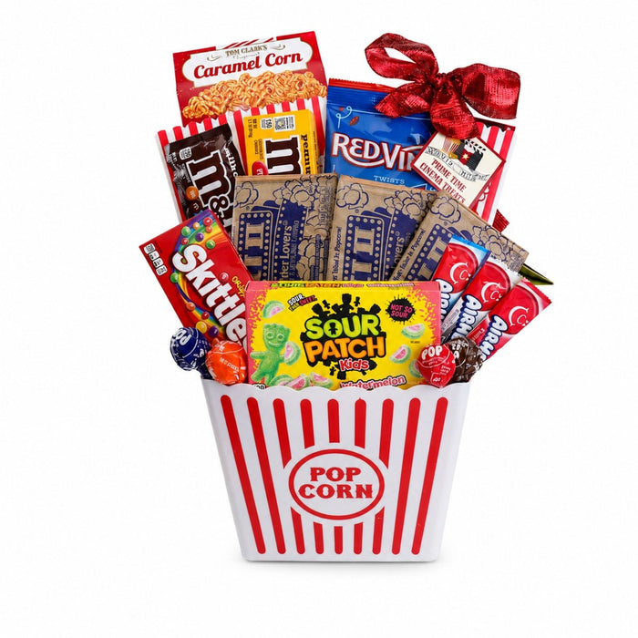 Movie night gift basket with red striped popcorn bucket and assorted candy bags