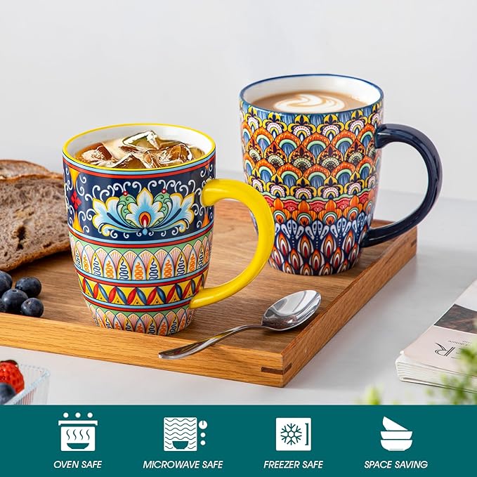 Two large boho ceramic coffee mugs with handles, colorful geometric and floral patterns on tray