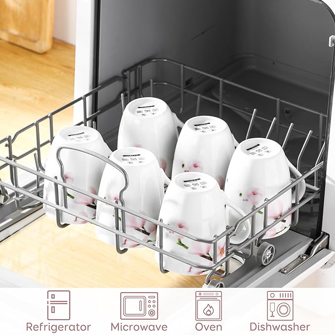 Floral ceramic coffee mugs in dishwasher rack, white cups with pink flower accents