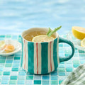 12oz ceramic coffee mug with teal and red vertical stripe design, curved handle
