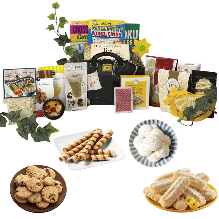 Assorted gift basket with black handbag, tea boxes, cookies and pastries, snack plates