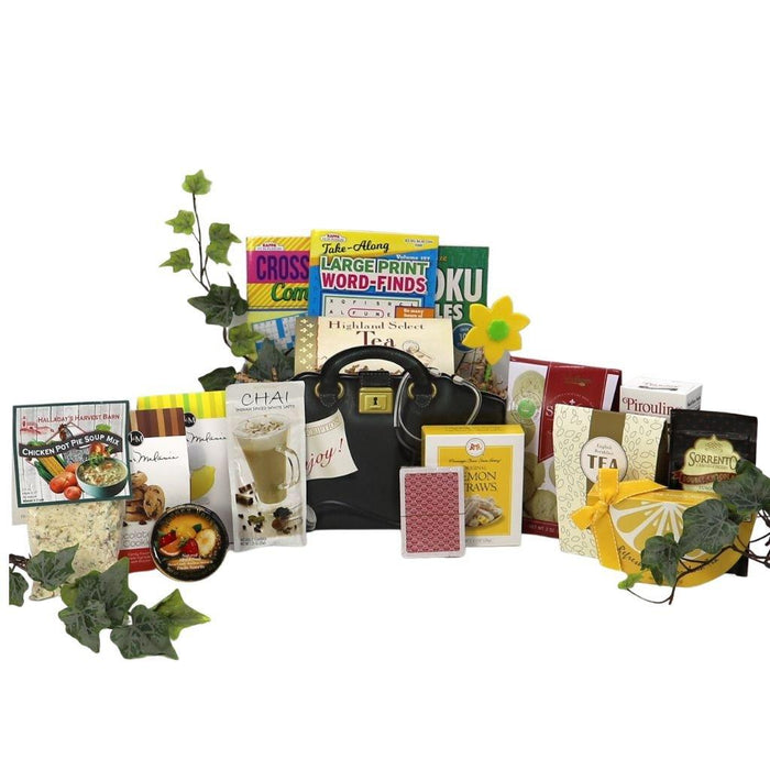 Assorted gift basket with black handbag and tea boxes, snack cookies and crackers