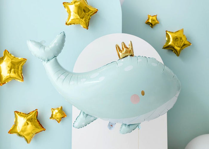 Light blue whale-shaped balloon with a small gold crown and gold star accents
