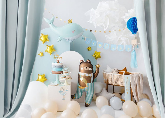 Light blue whale-shaped balloon with gold star decorations and a small crown