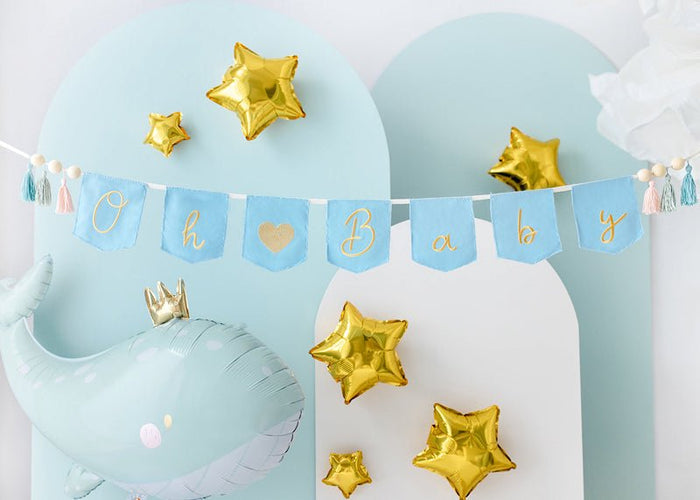 Light blue whale-shaped balloon with gold star charms and a small gold crown