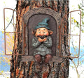 Garden gnome statue with teal cap and beard, seated inside tree trunk doorway