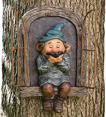 Front view garden gnome statue with teal hat and beard behind arched tree door
