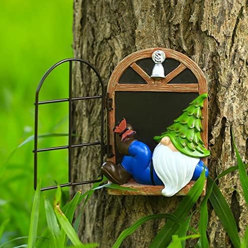 Outdoor gnome figurine beside a black window panel on a wooden arched tree decor