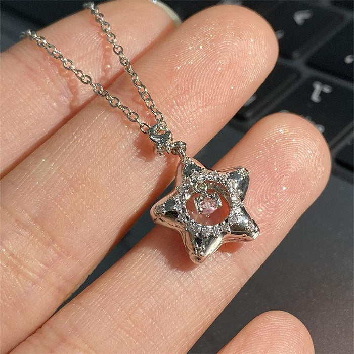 Star pendant necklace worn on hand, silver tone star charm with pink center crystal