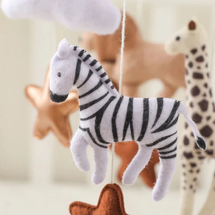 Felt zebra toy with hanging loop on a crib mobile bell