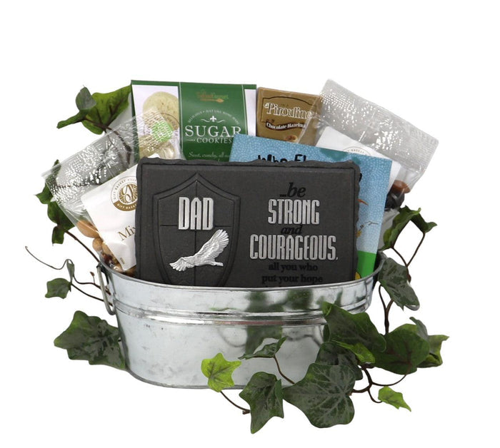 Metal gift tin with green leaves and black dad slogan patch, holding assorted food packs