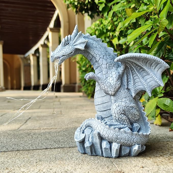 Blue dragon garden statue with solar LED light strings, seated on rock on patio