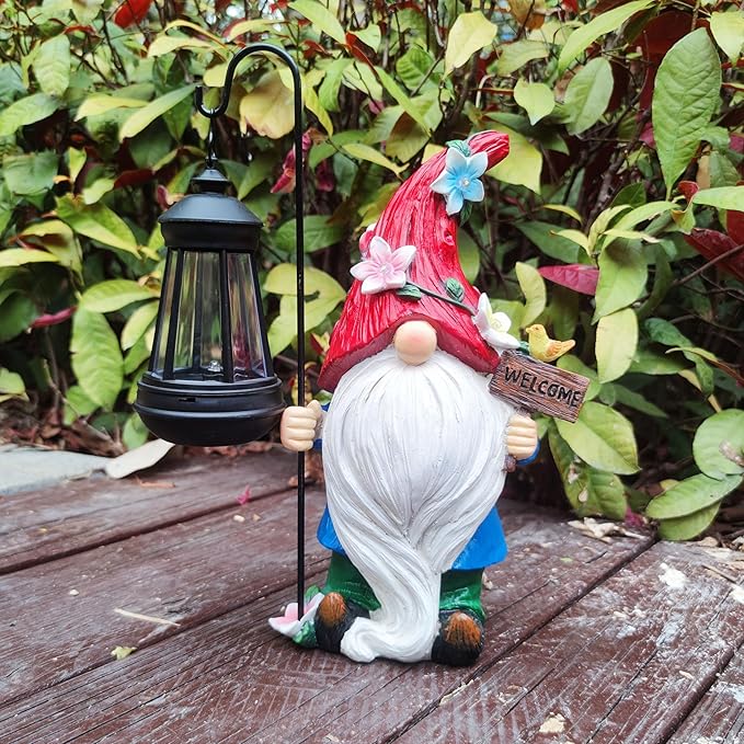 Garden gnome figurine with solar lantern, red-and-white hat, smiling face and welcome sign