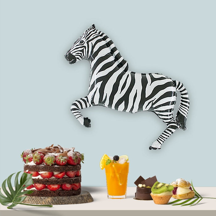 Zebra balloon in black-and-white stripes, standing sideways with curled tail and bent legs