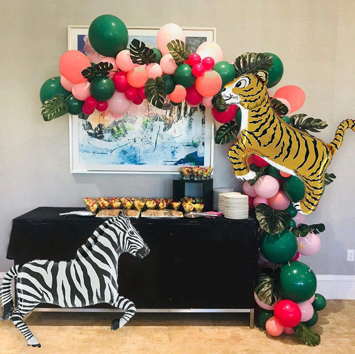 Zebra balloon figure with black-and-white stripes and raised head, with balloons nearby