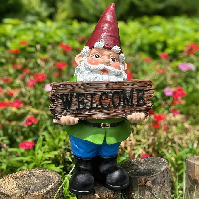 Garden gnome statue holding a brown wood-look “WELCOME” sign, green shirt, blue pants.