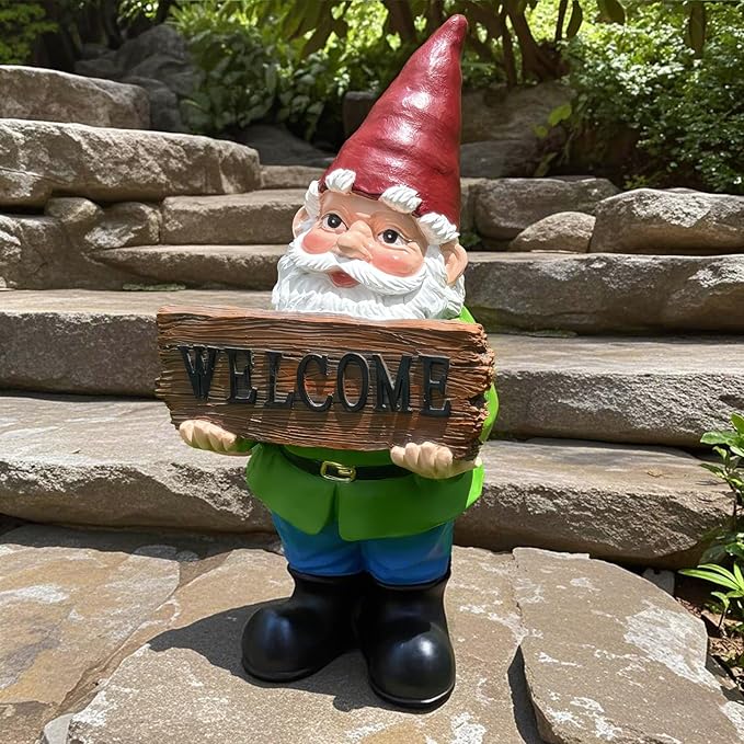 Garden gnome statue holding a “WELCOME” sign, red hat and white beard, green top, blue pants.