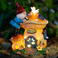 Solar garden gnome figurine with glowing lantern house, red hat, blue coat